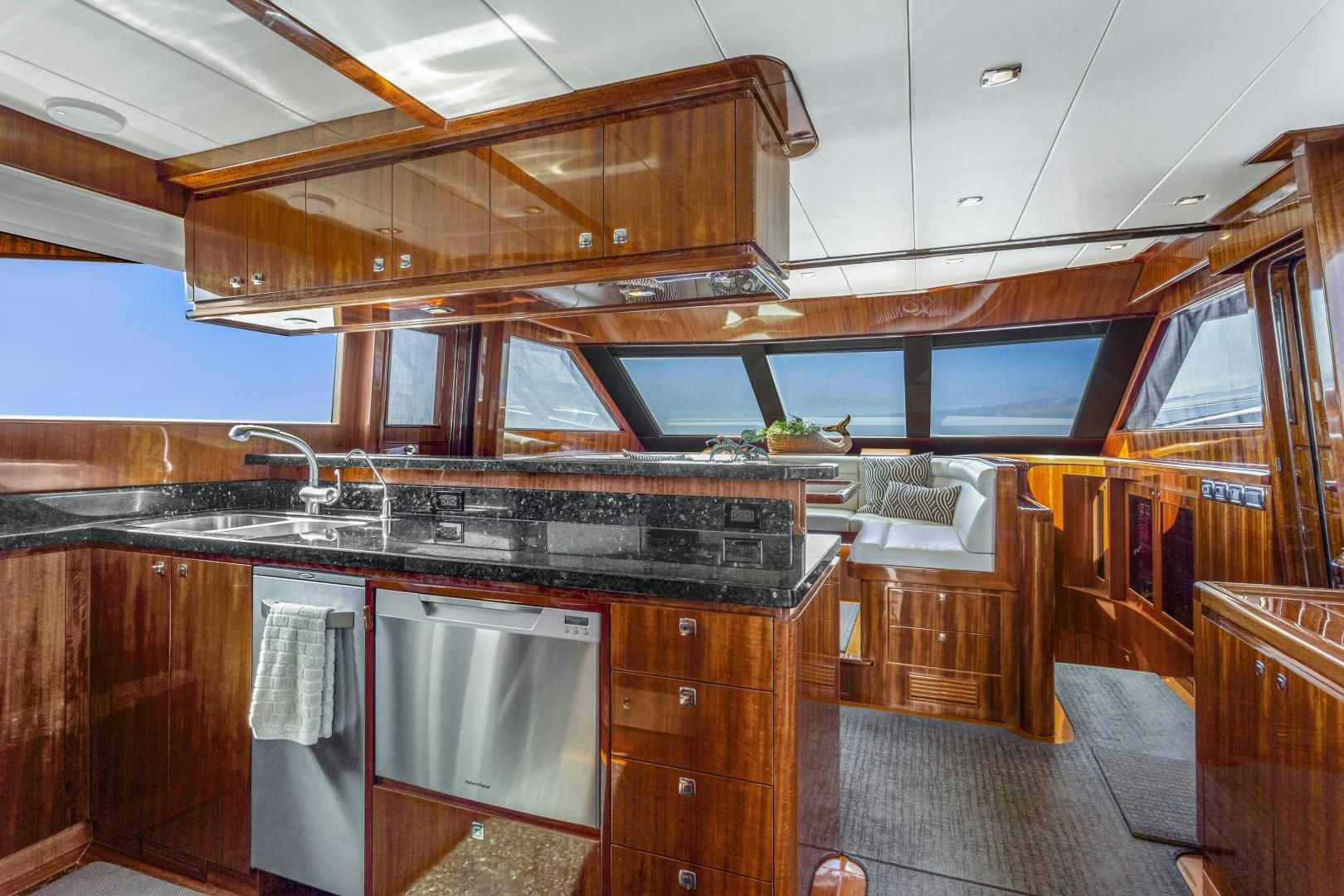 a kitchen with wooden cabinets aboard ODYSEA Yacht for Sale