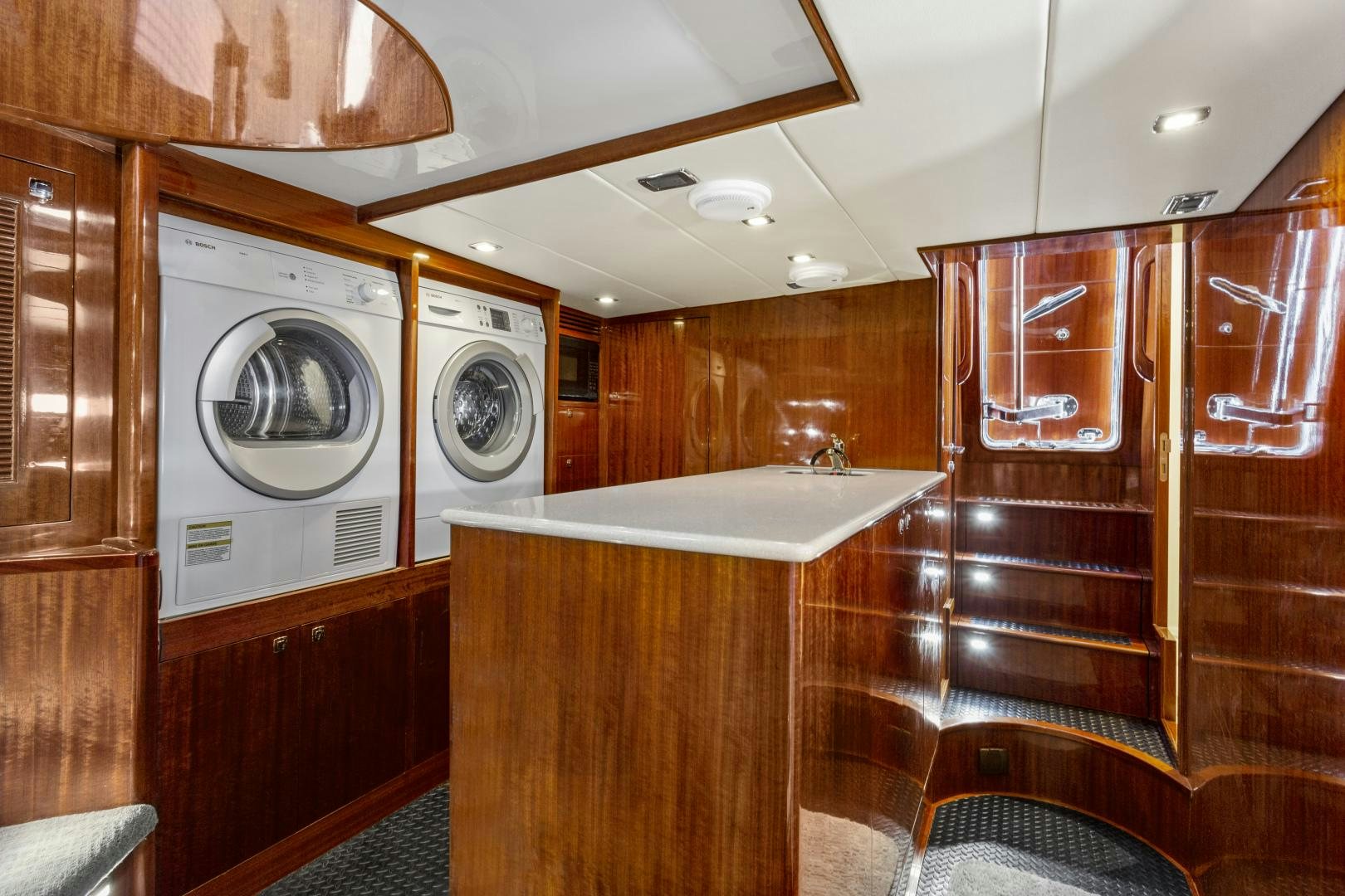 a room with wooden cabinets aboard ODYSEA Yacht for Sale