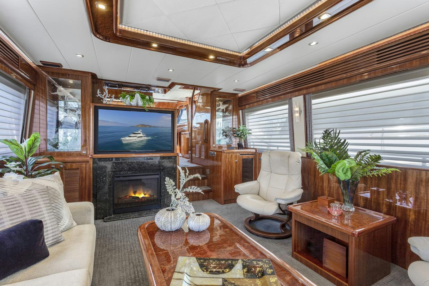 a living room with a fireplace aboard ODYSEA Yacht for Sale
