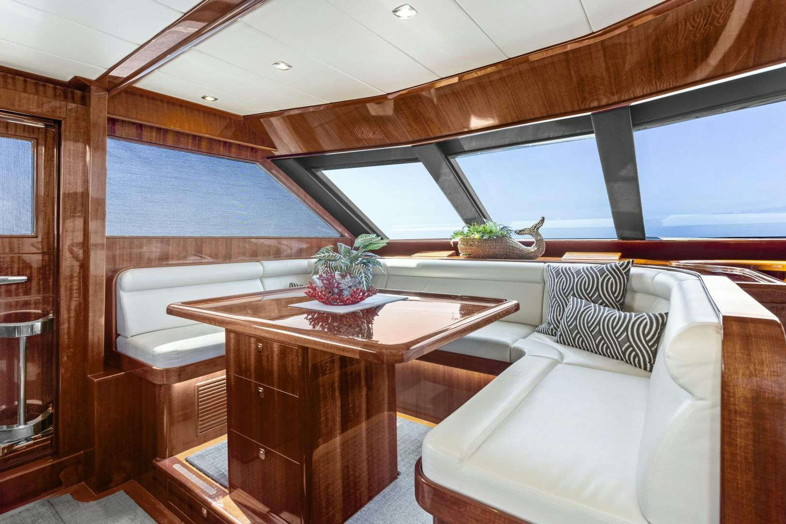 a room with a table and couch aboard ODYSEA Yacht for Sale
