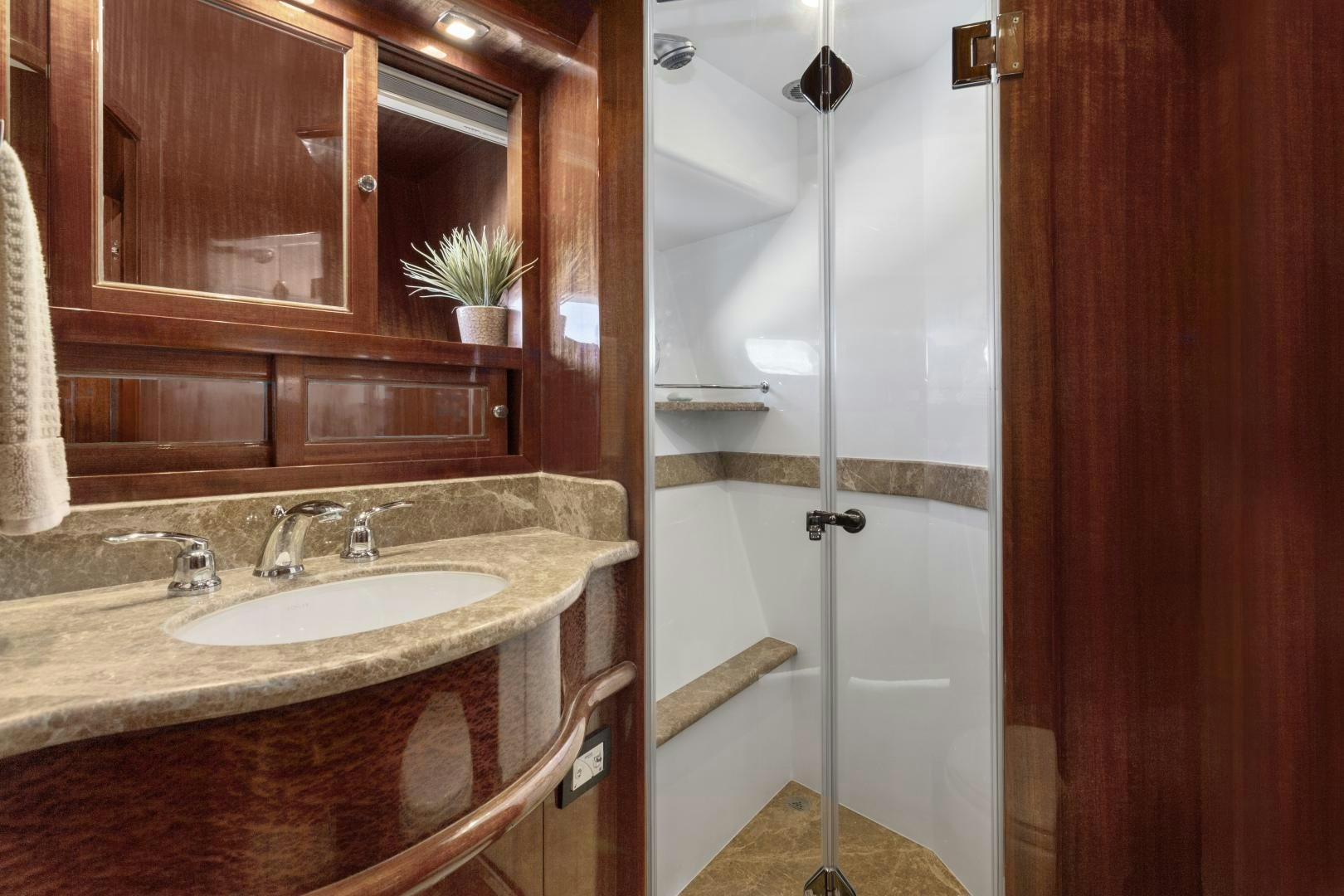 a bathroom with a glass shower door aboard ODYSEA Yacht for Sale