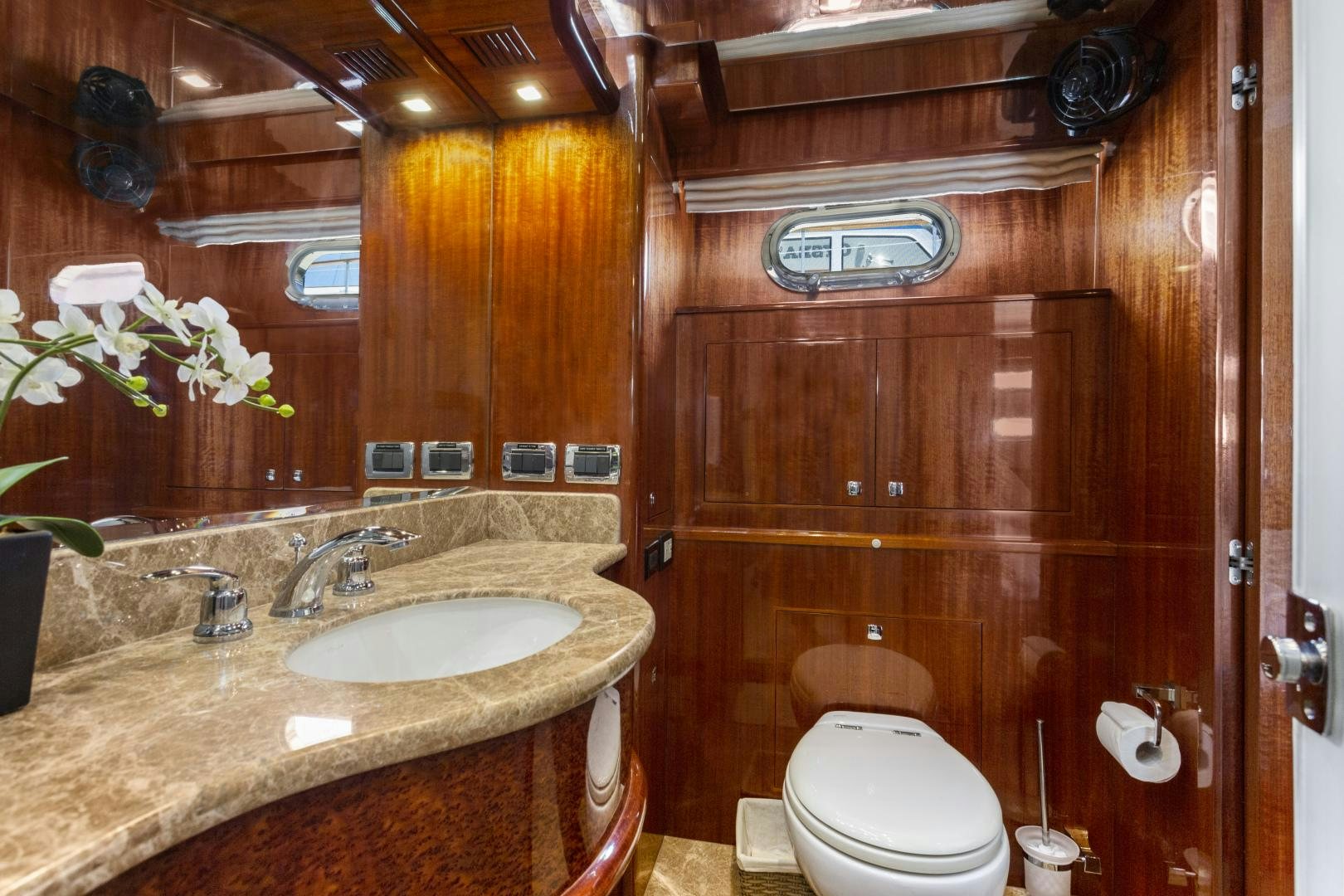 a bathroom with a sink toilet and a mirror aboard ODYSEA Yacht for Sale