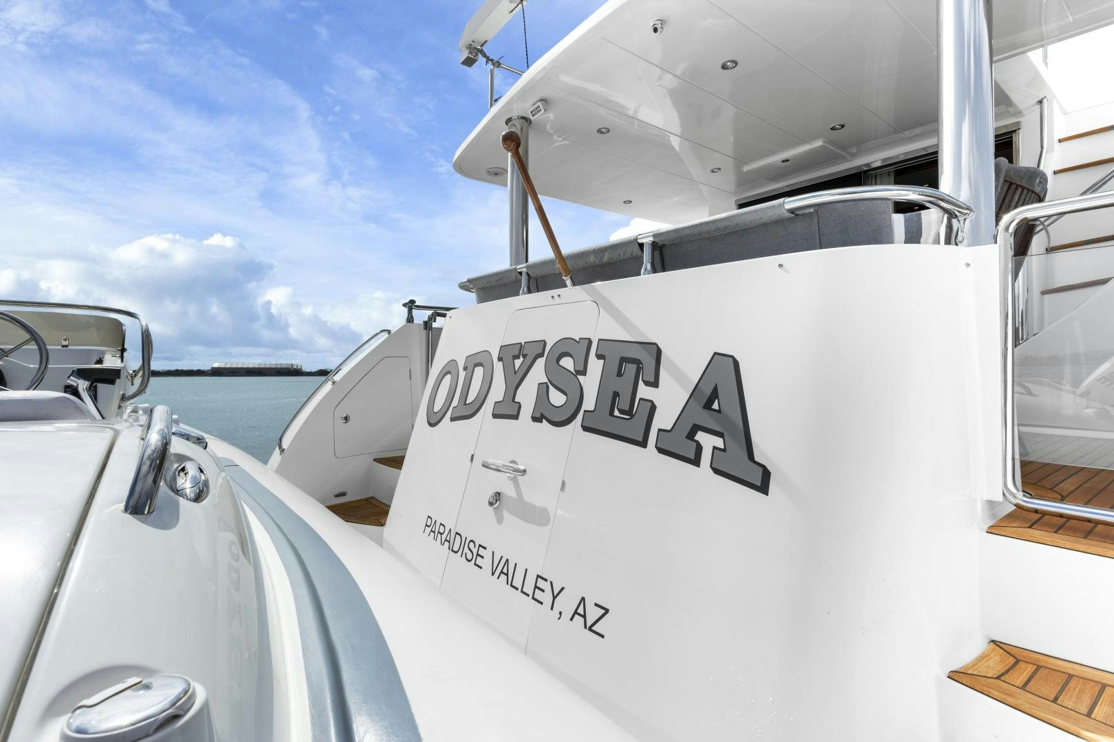 a white boat with black text on it aboard ODYSEA Yacht for Sale