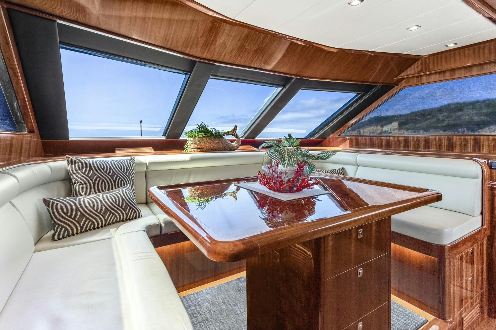 a table with a plant on it aboard ODYSEA Yacht for Sale