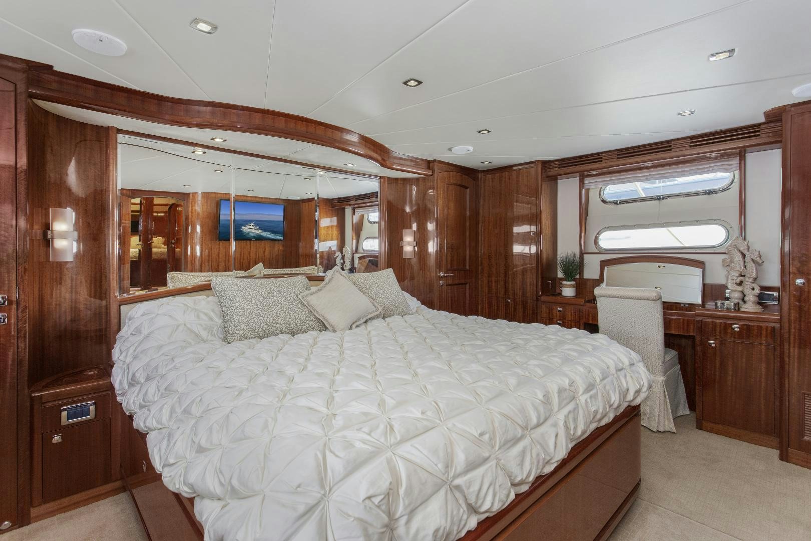 a large bedroom with wood walls aboard ODYSEA Yacht for Sale