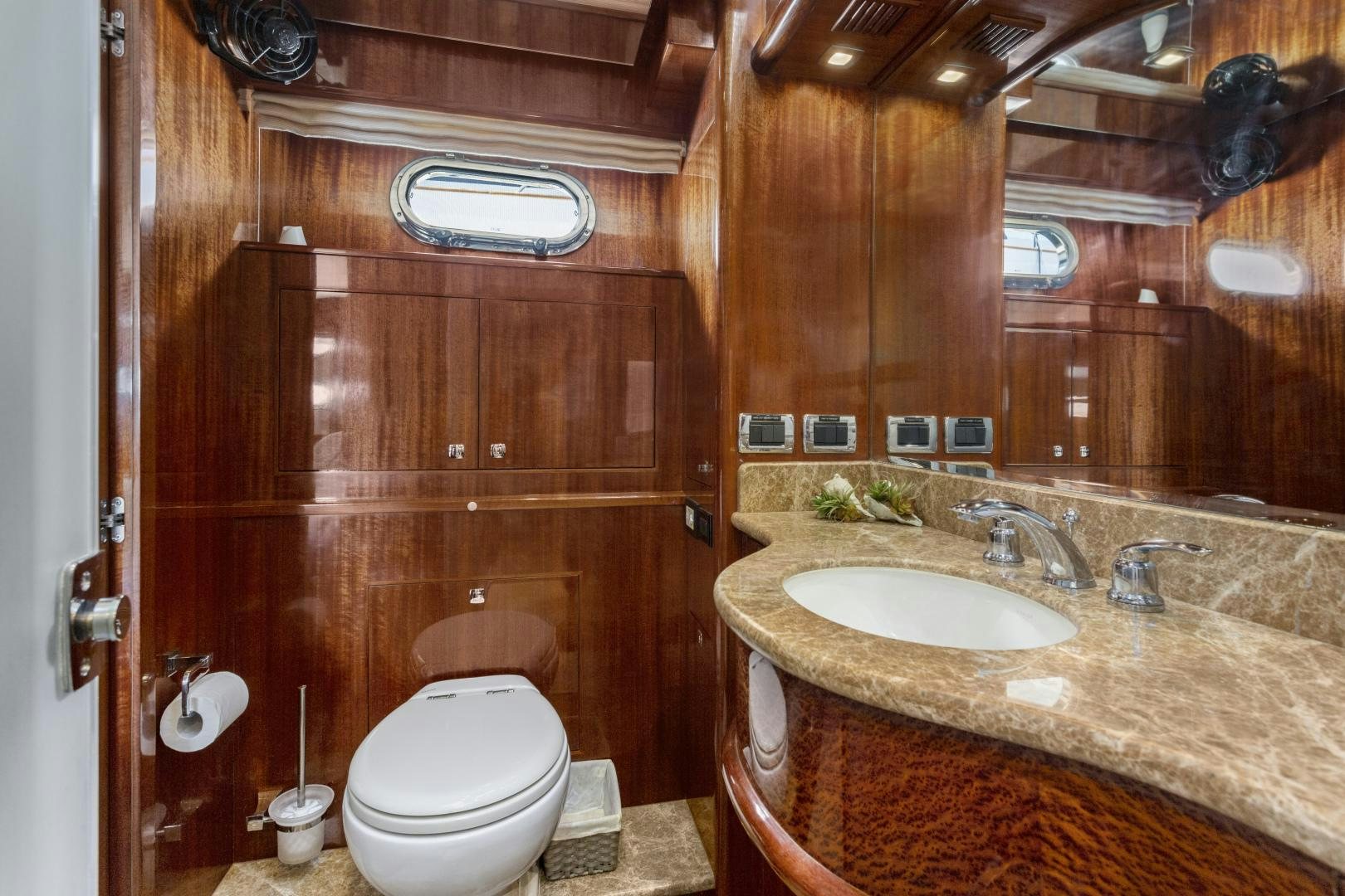 a bathroom with a sink toilet and a mirror aboard ODYSEA Yacht for Sale