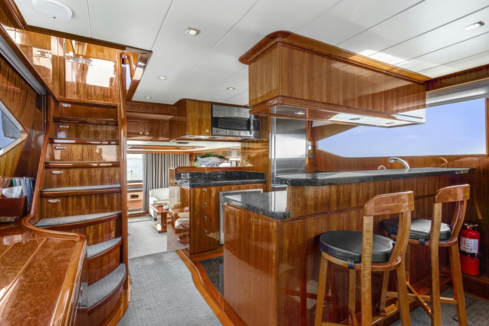 a room with wooden bunk beds aboard ODYSEA Yacht for Sale