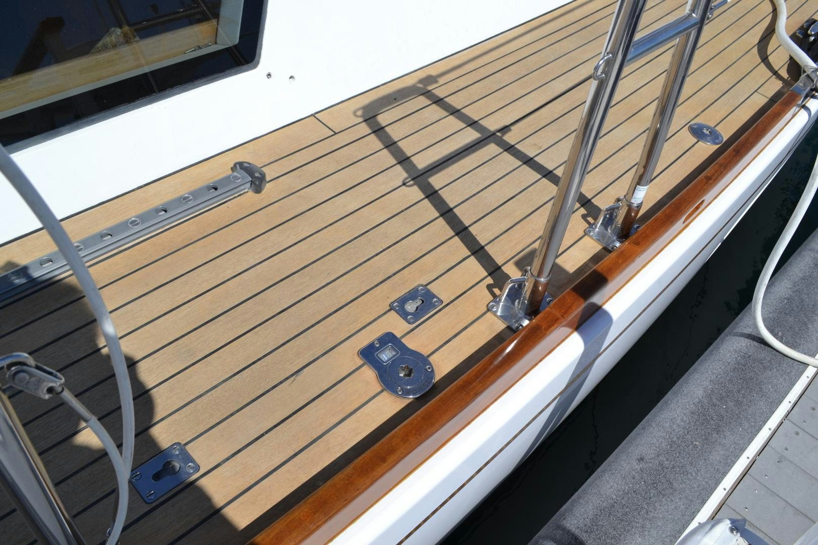 a wooden bench with a metal frame aboard MEHETABEL Yacht for Sale