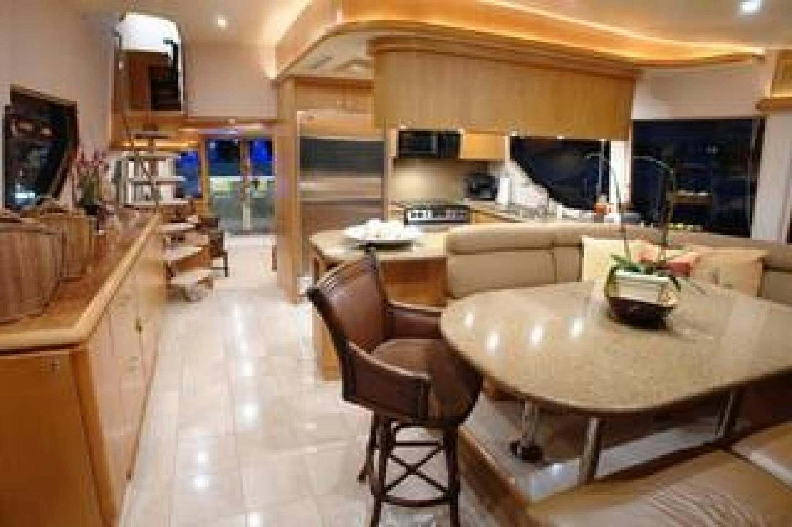 a large kitchen with a table and chairs aboard No Name Yacht for Sale
