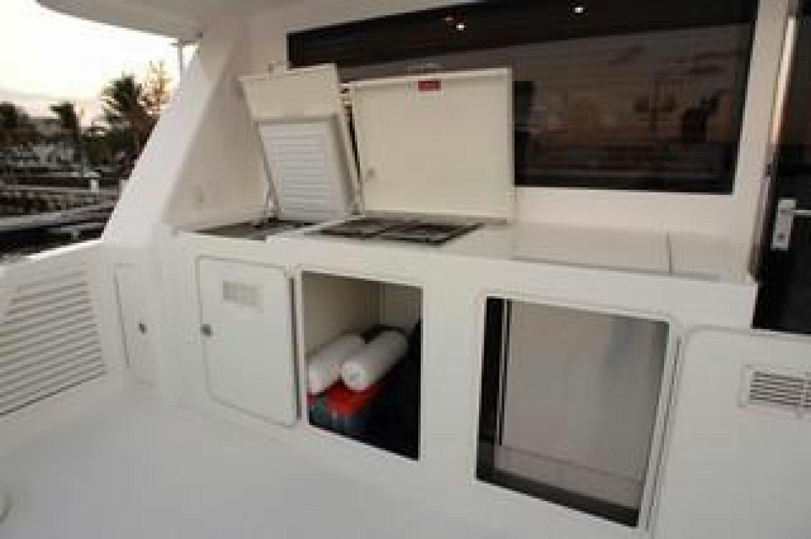 a white car with a computer on top of it aboard No Name Yacht for Sale
