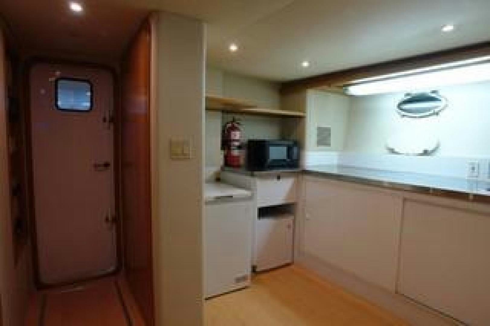 a kitchen with a microwave oven and a refrigerator aboard No Name Yacht for Sale