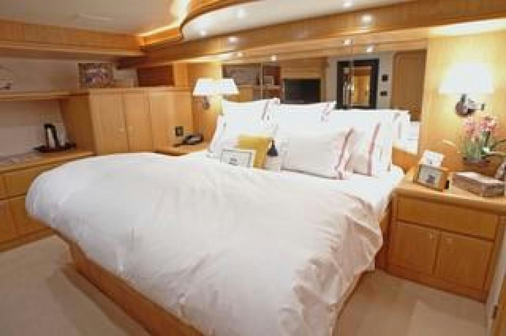 a bed with white sheets aboard No Name Yacht for Sale