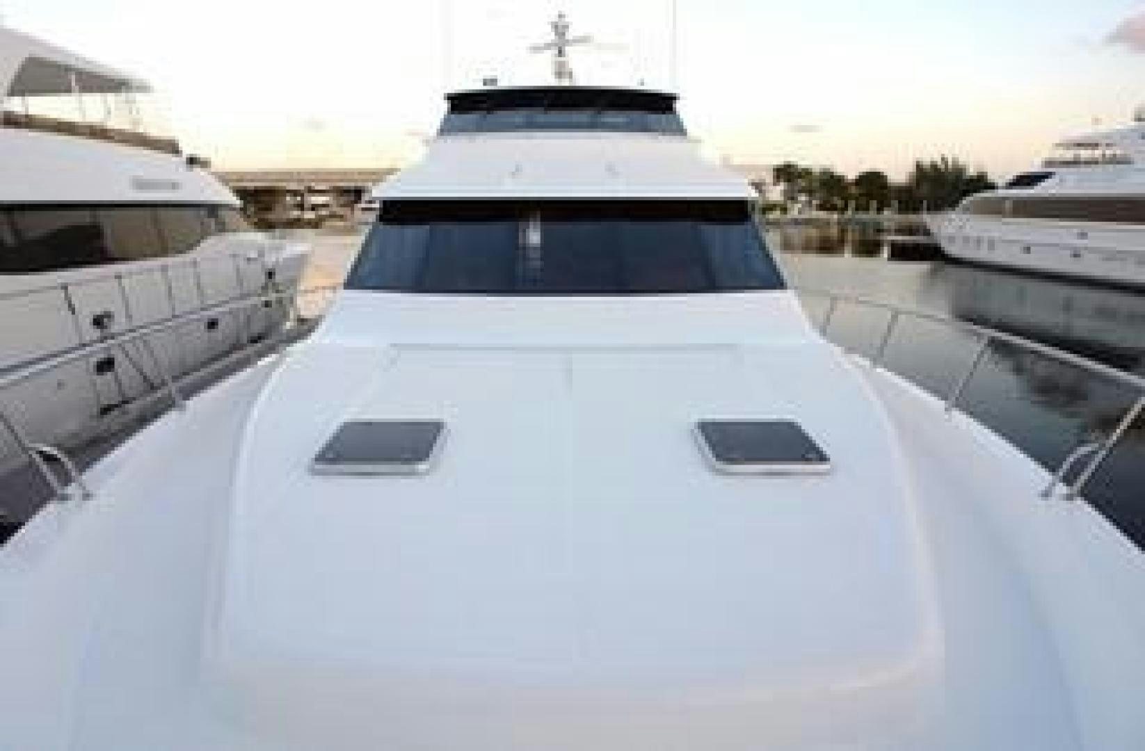 a white yacht in a harbor aboard No Name Yacht for Sale