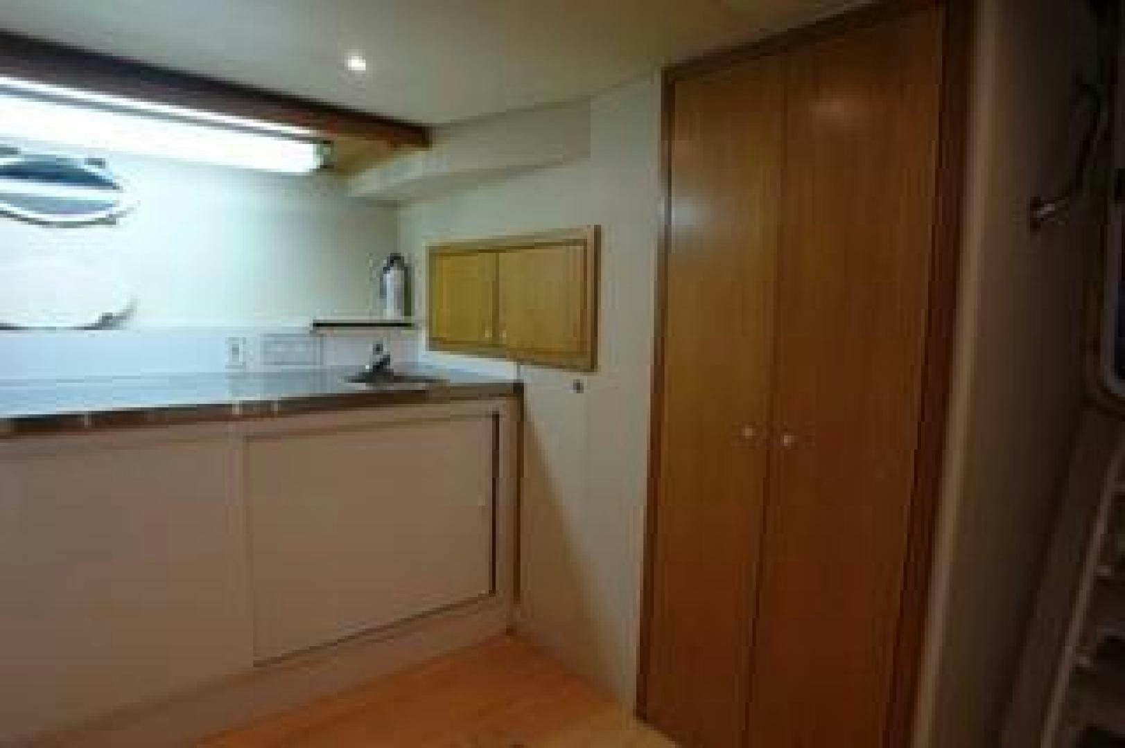 a kitchen with white cabinets aboard No Name Yacht for Sale
