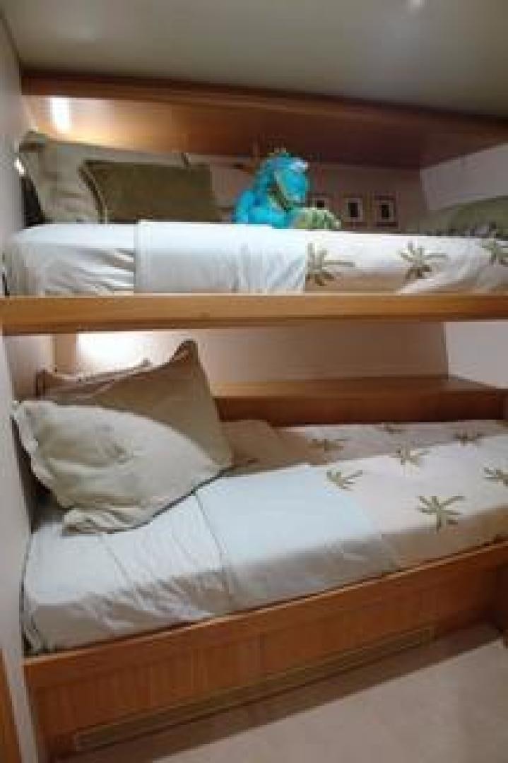 a bed with a white sheet and pillows on it aboard No Name Yacht for Sale