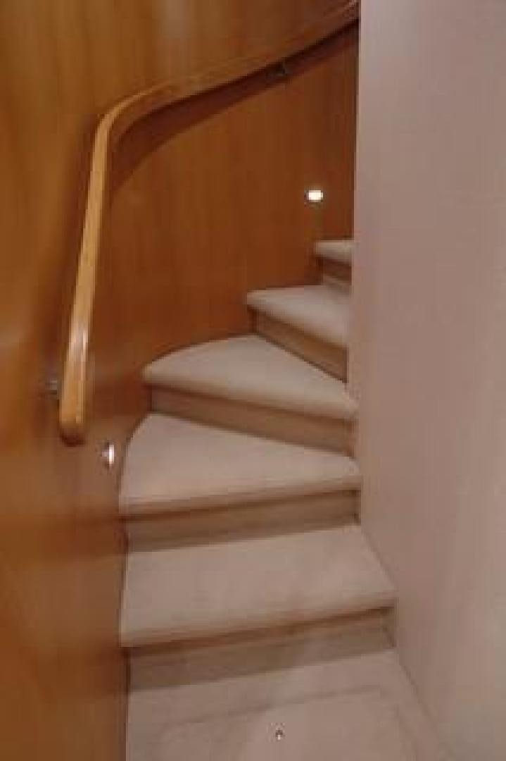 a staircase with a wood railing aboard No Name Yacht for Sale