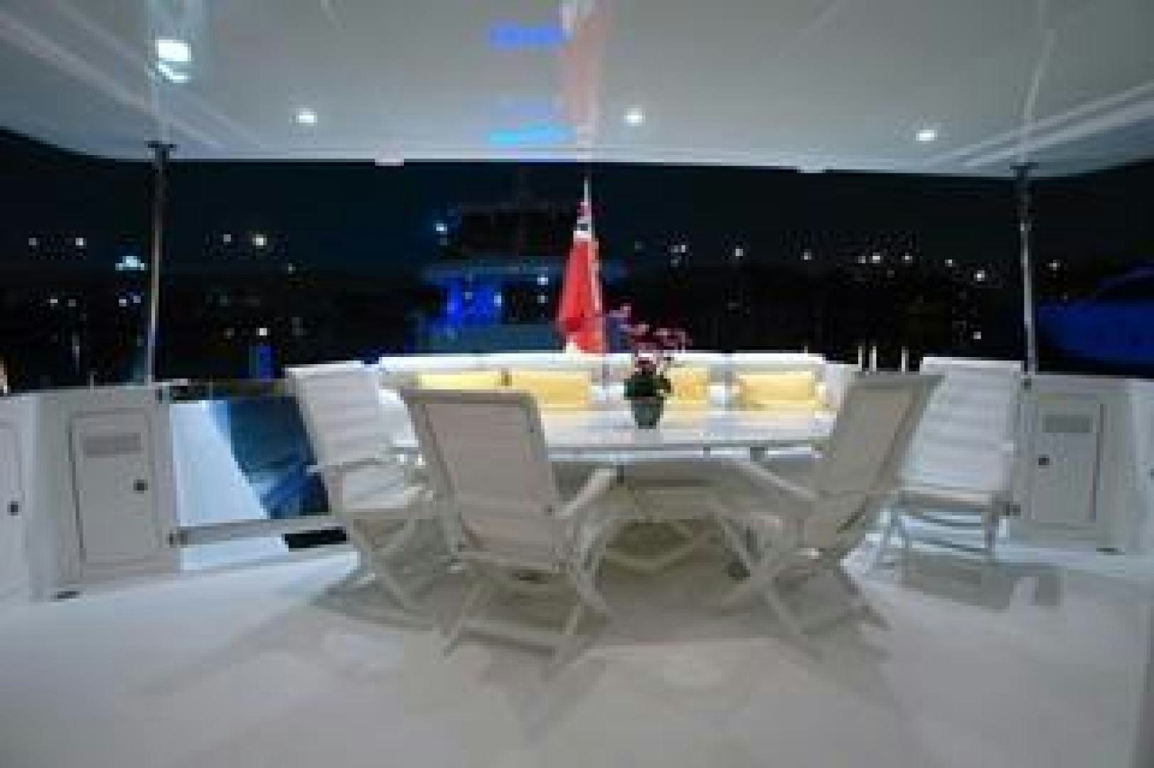 a room with a table chairs and a red and white flag aboard No Name Yacht for Sale
