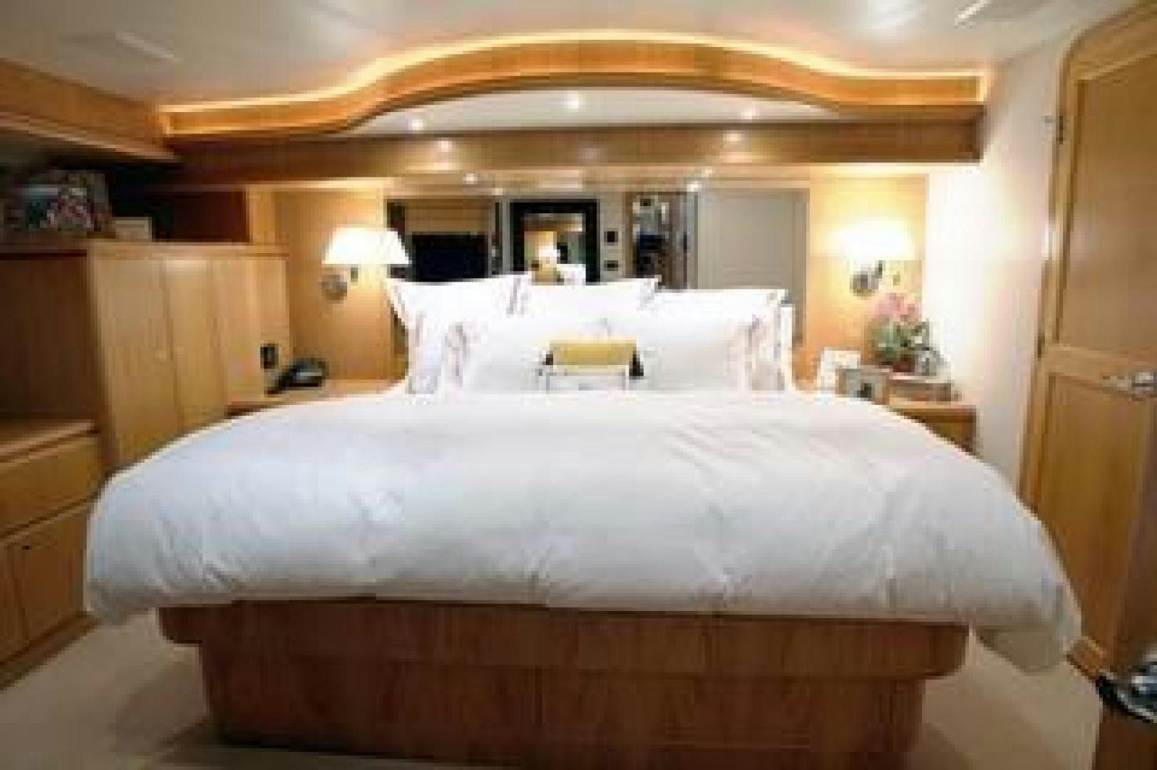 a large bed in a hotel room aboard No Name Yacht for Sale