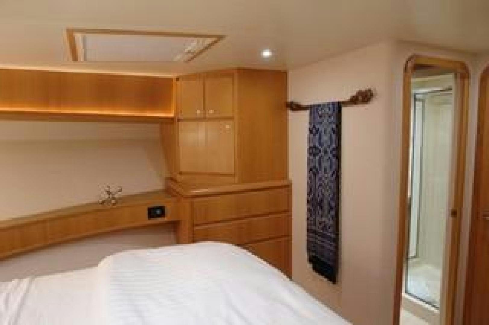 a bedroom with a bed and cabinets aboard No Name Yacht for Sale
