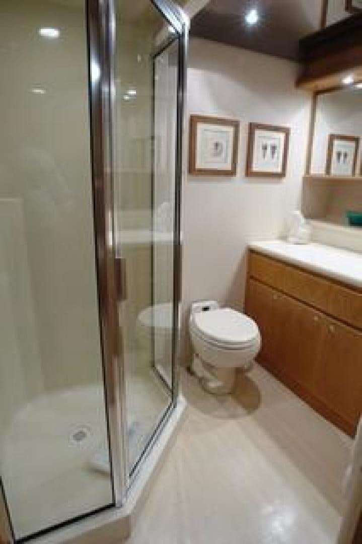 a bathroom with a glass shower aboard No Name Yacht for Sale