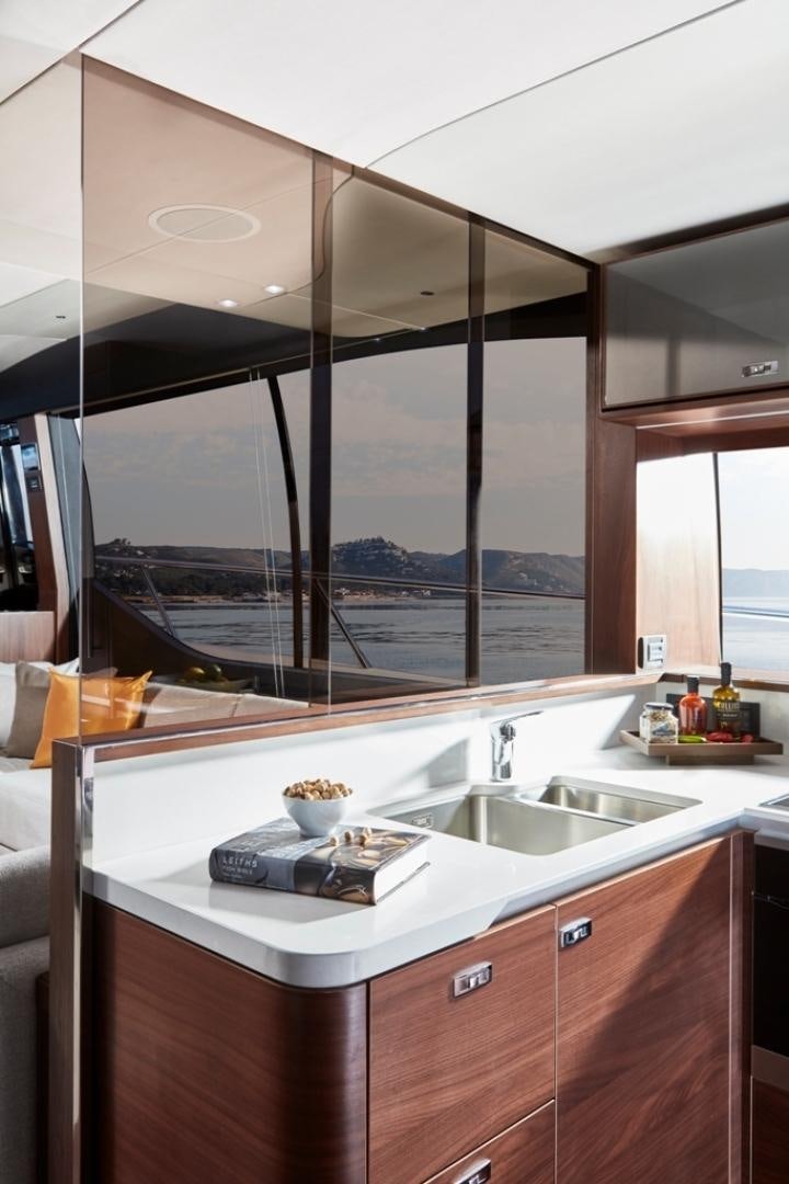 a kitchen with a large window aboard S78  Yacht for Sale