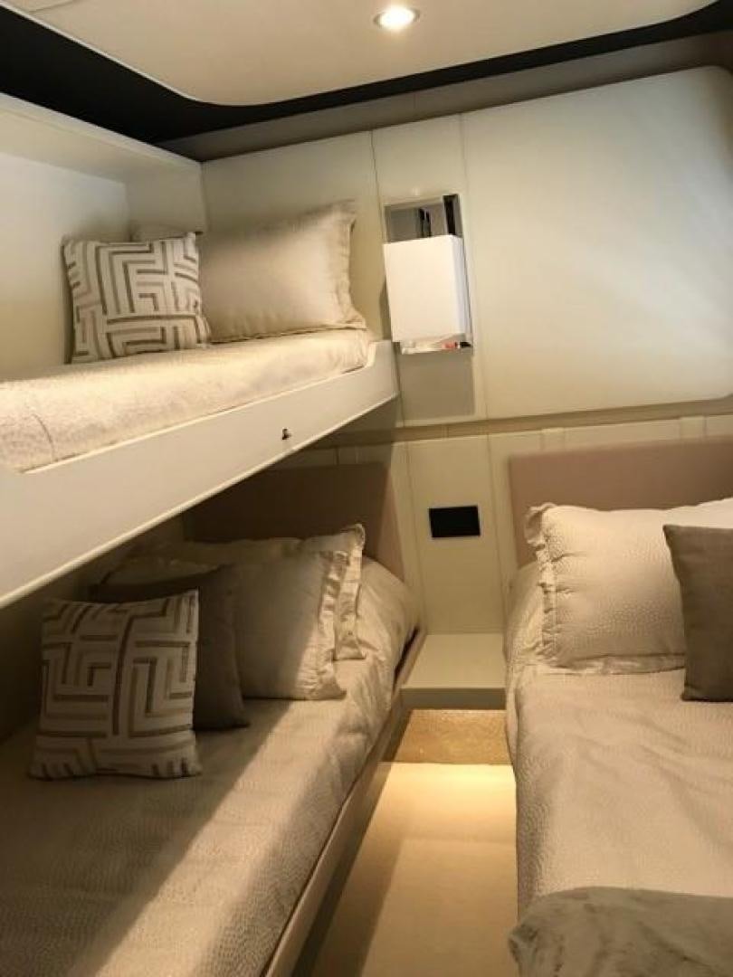 a room with a bed and a lamp on the wall aboard SILVER SKY 2.0 Yacht for Sale