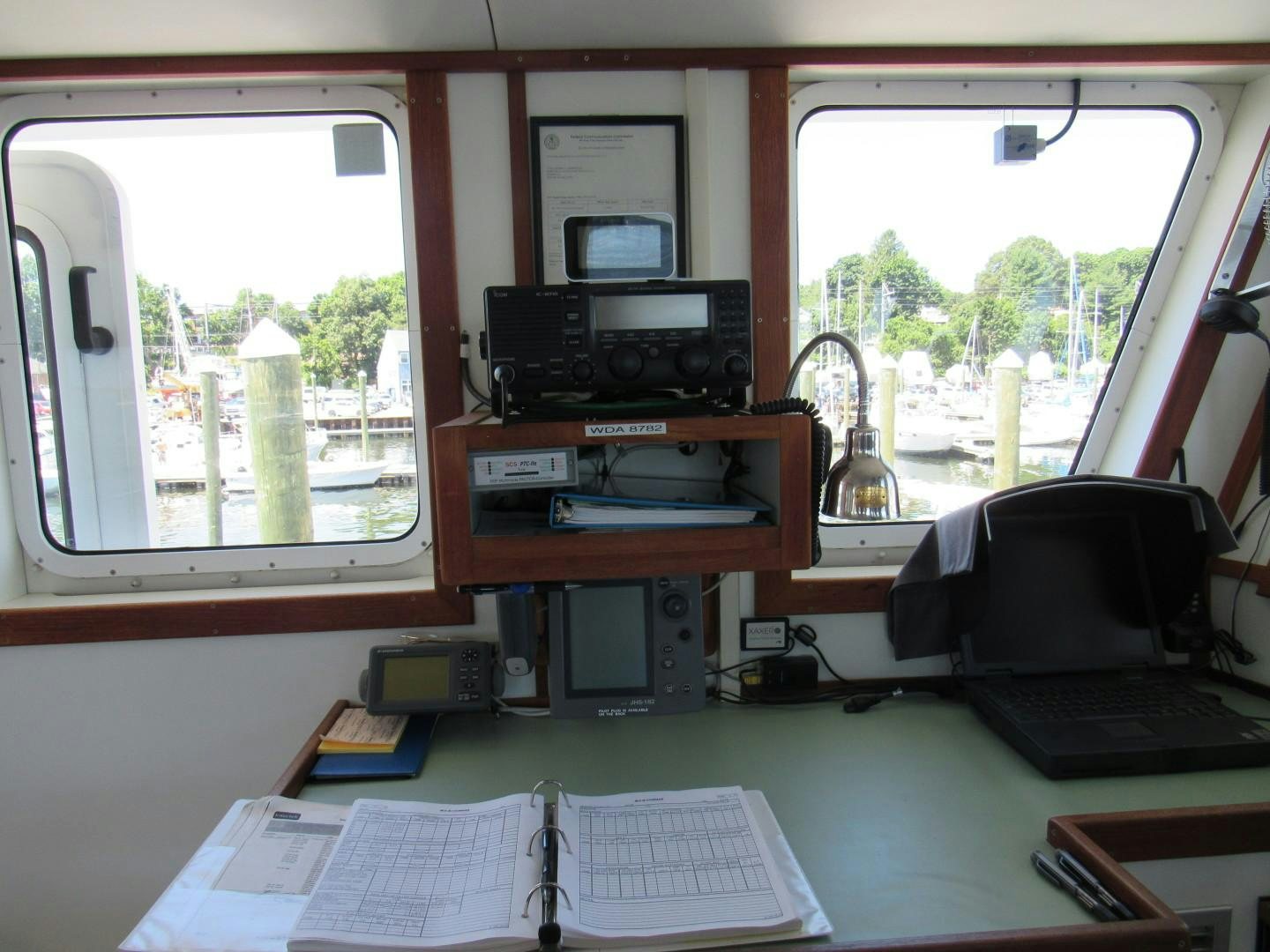a desk with a computer and other office equipment aboard KITTIWAKE Yacht for Sale