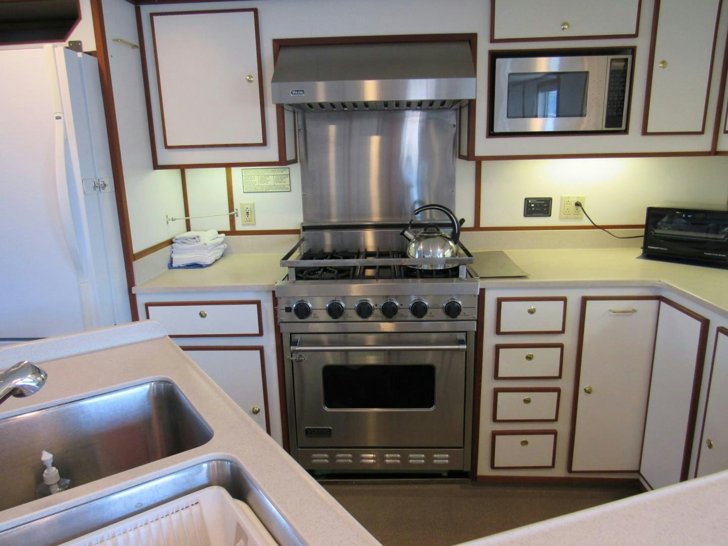 a kitchen with a stove and sink aboard KITTIWAKE Yacht for Sale