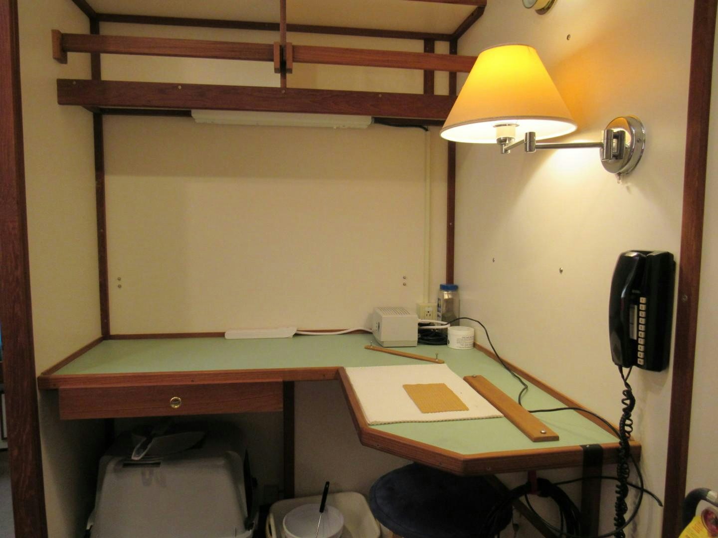 a desk with a computer and a lamp on it aboard KITTIWAKE Yacht for Sale