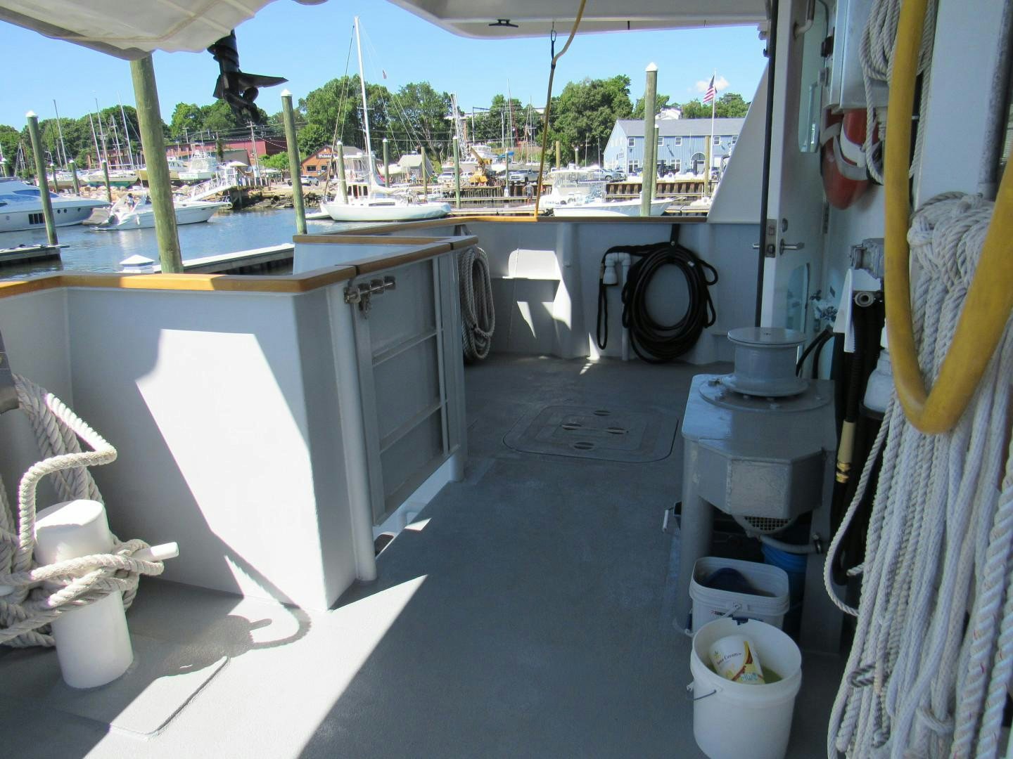 a room with a white table and white containers aboard KITTIWAKE Yacht for Sale
