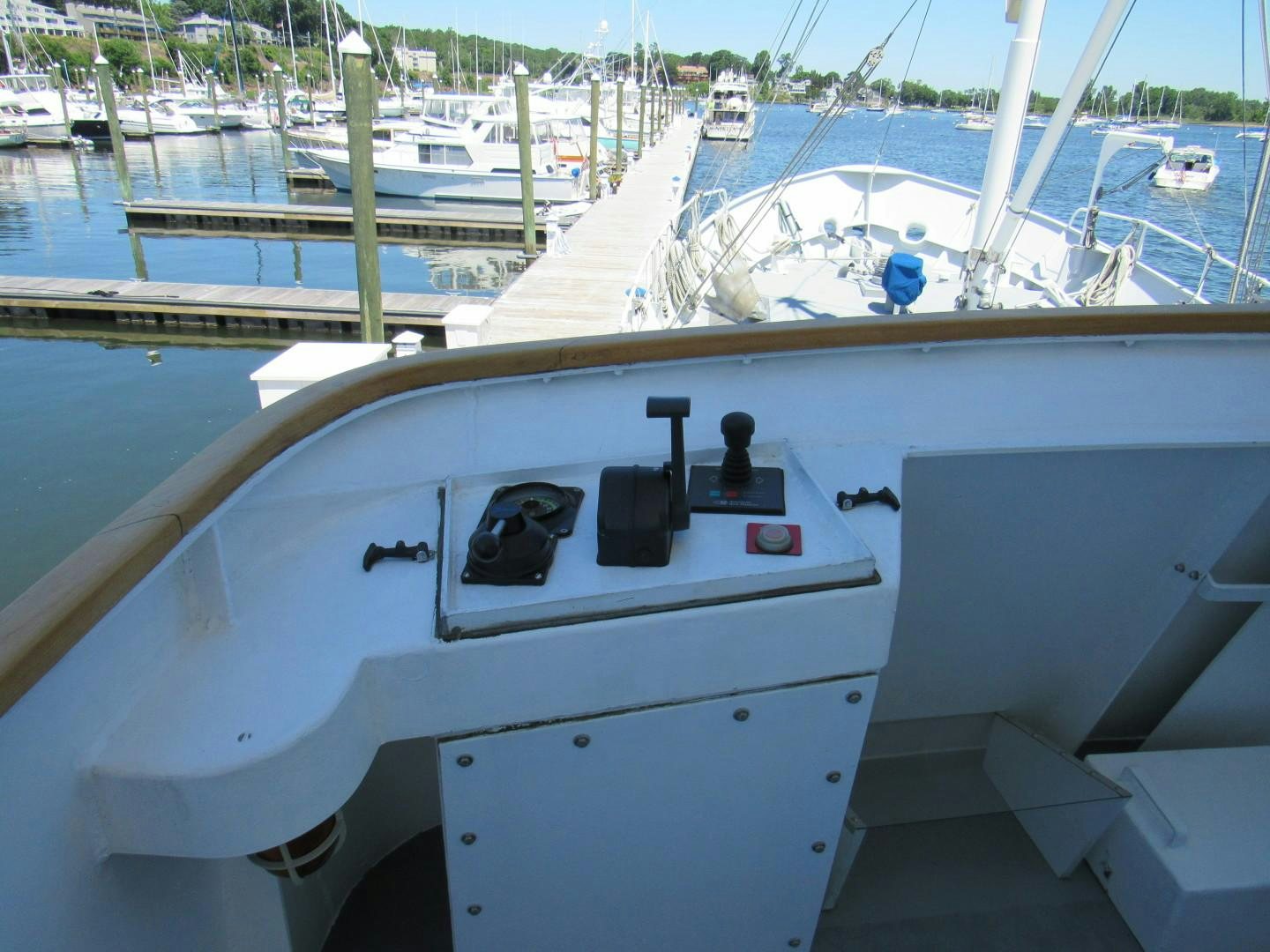 a white boat in a harbor aboard KITTIWAKE Yacht for Sale