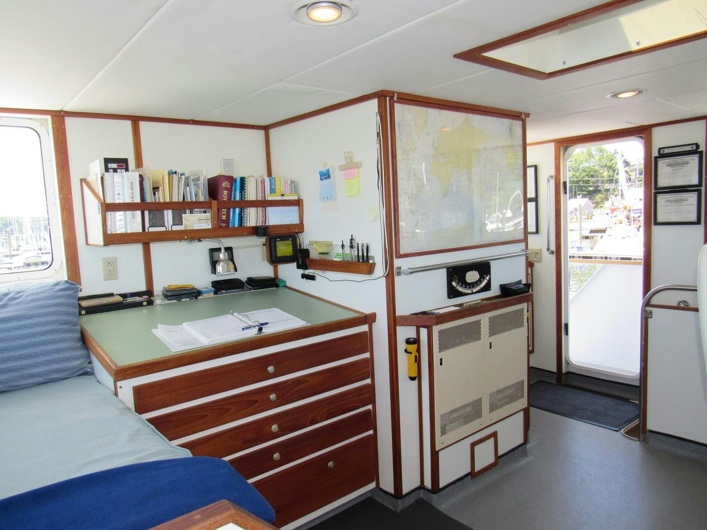 a room with a desk and a bed aboard KITTIWAKE Yacht for Sale