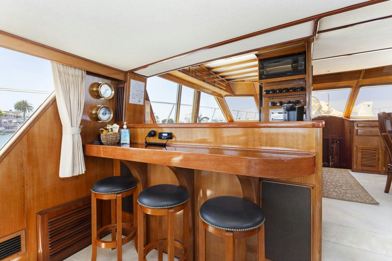 a wooden table with stools and stools aboard EL AMO Yacht for Sale