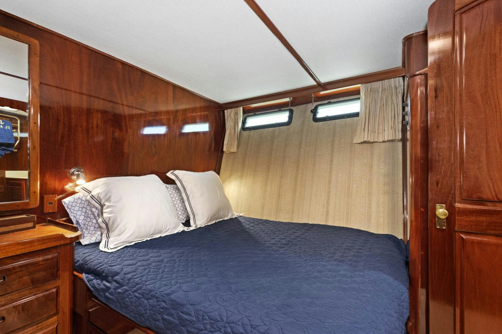 a bed with a blue comforter aboard EL AMO Yacht for Sale