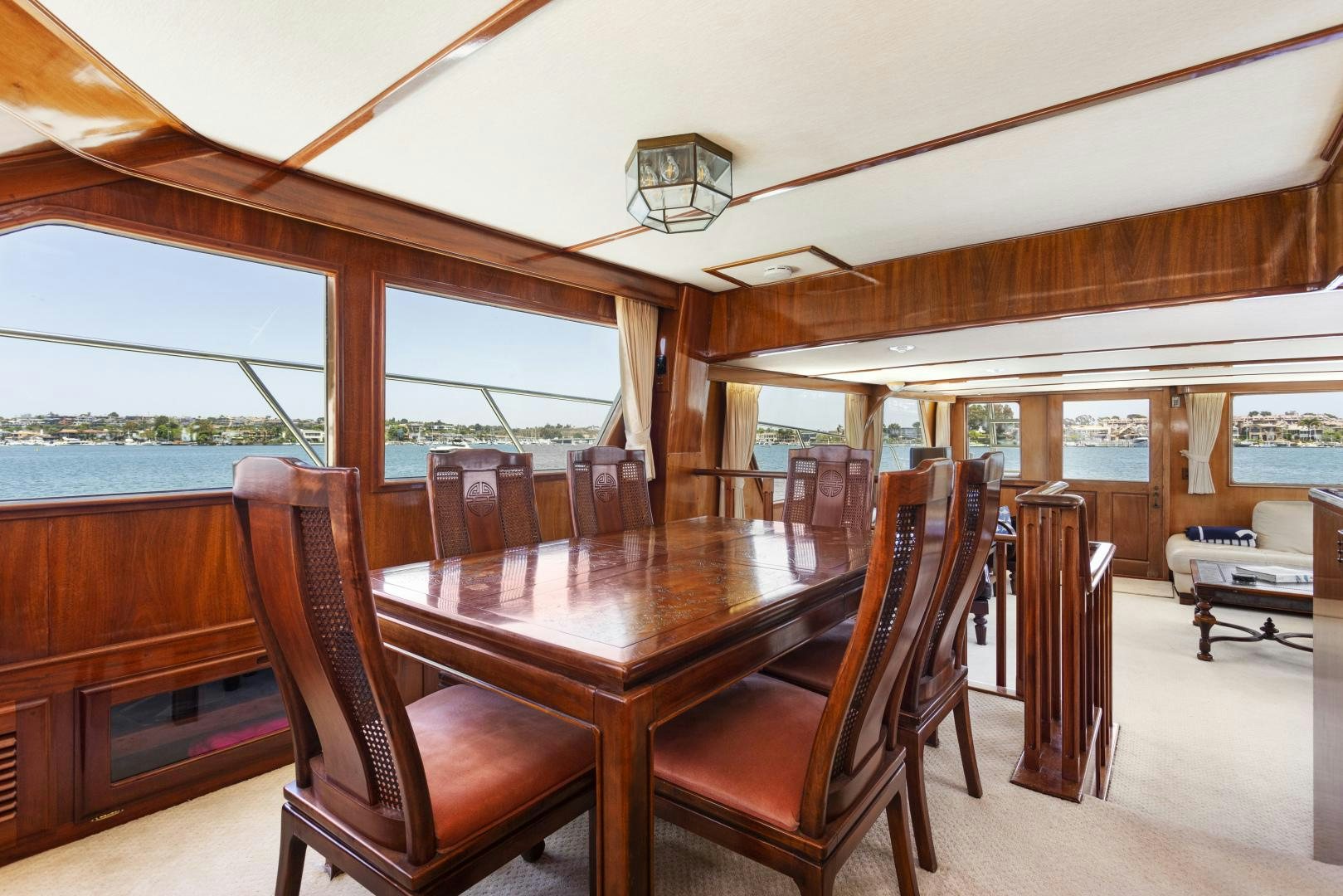 a wood table and chairs on a boat aboard EL AMO Yacht for Sale