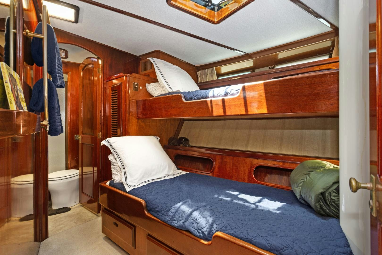 a bed with a blue sheet aboard EL AMO Yacht for Sale