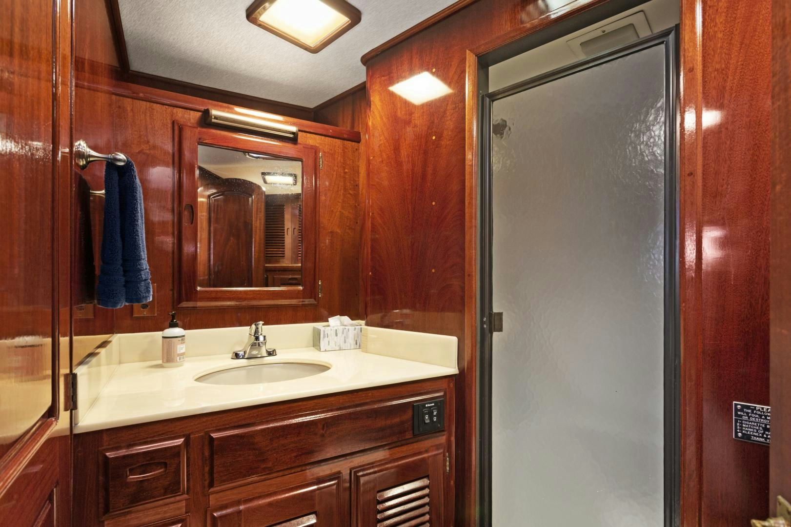 a bathroom with a sink and a mirror aboard EL AMO Yacht for Sale