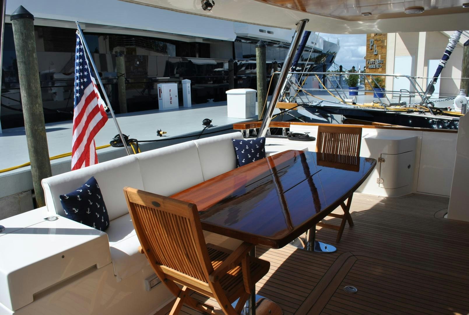 a table with chairs and a flag aboard KRYSKAR Yacht for Sale