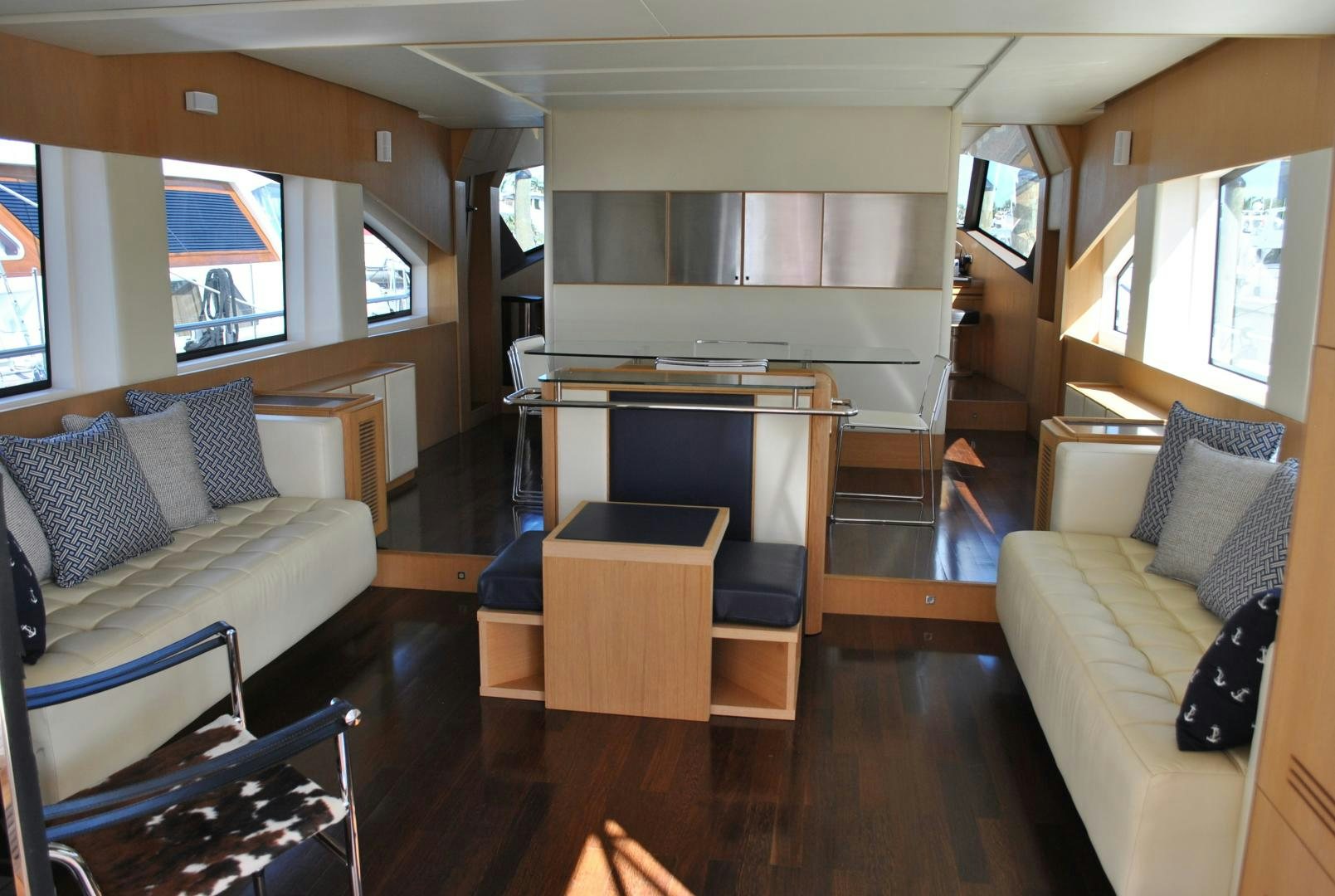 a living room with a couch and a piano aboard KRYSKAR Yacht for Sale