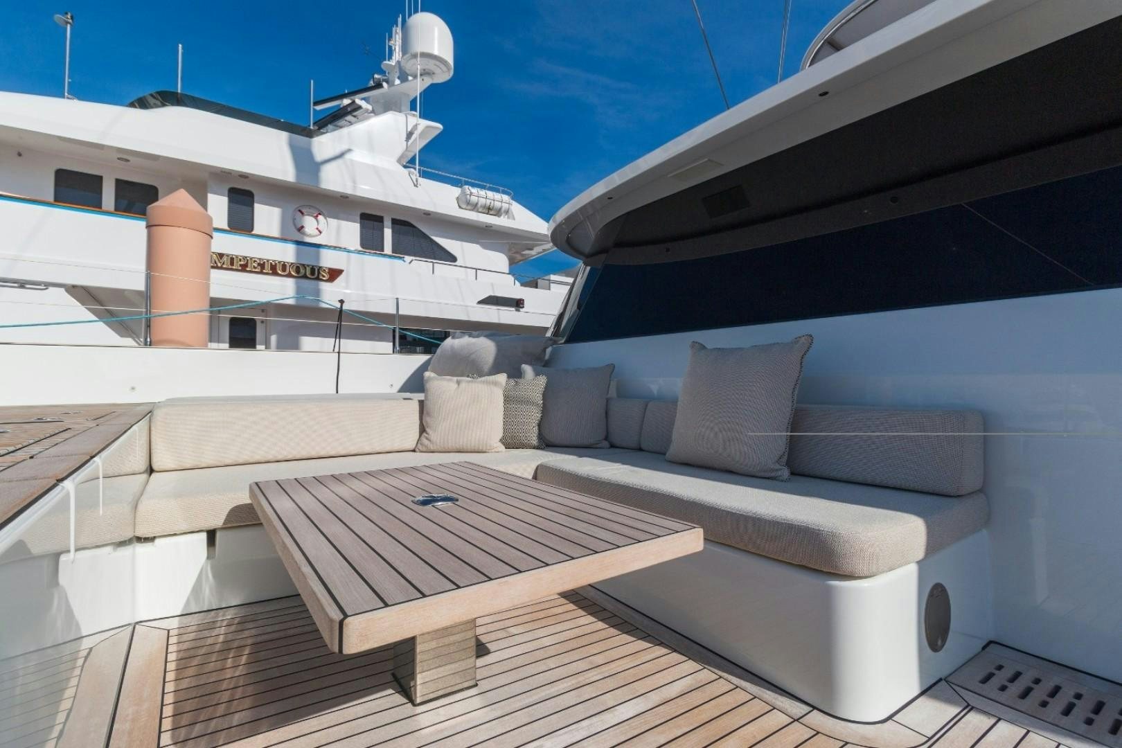 a white couch on a deck aboard OCEAN VIBES Yacht for Sale