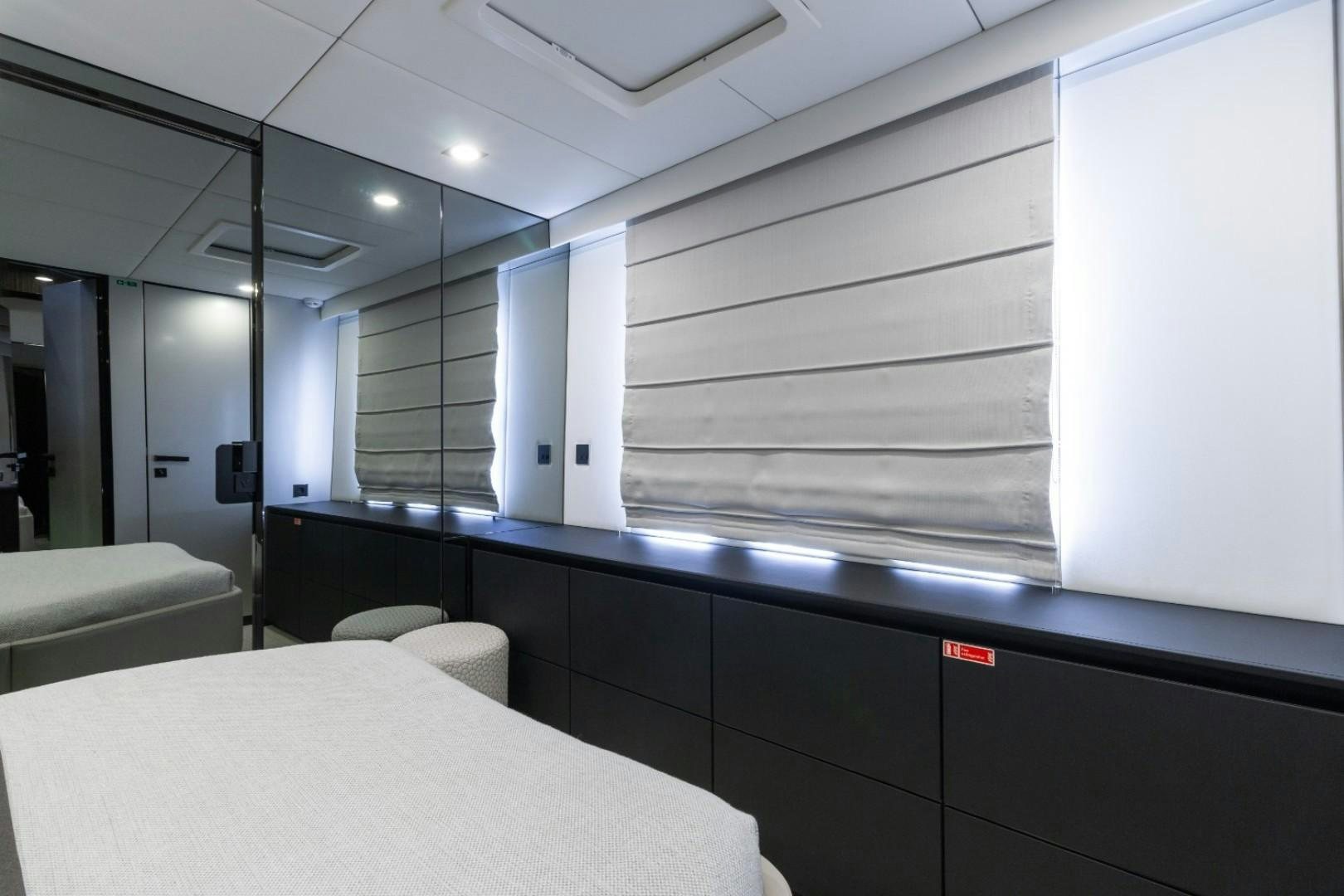 a room with a table and chairs aboard OCEAN VIBES Yacht for Sale