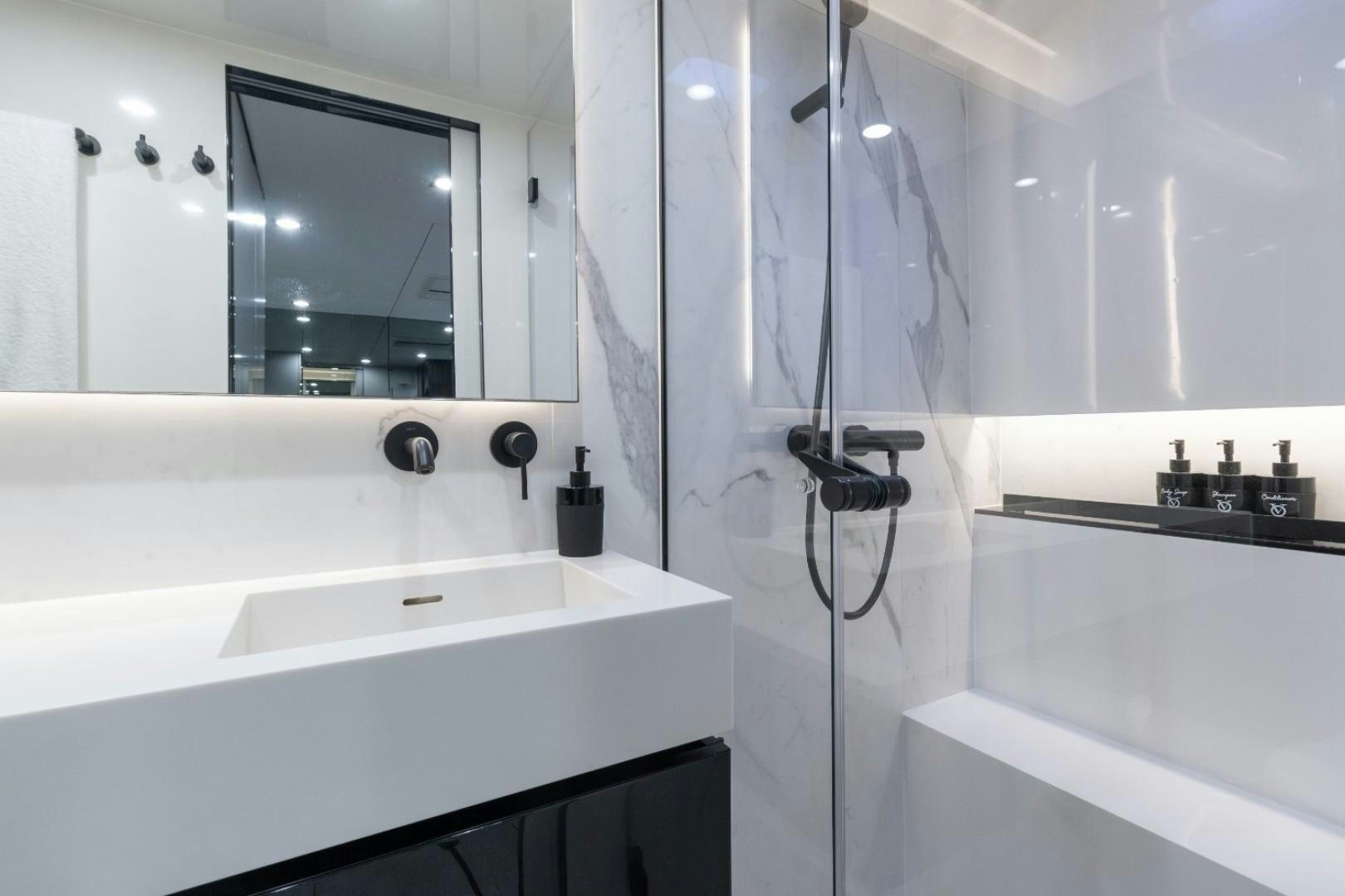 a bathroom with a shower and sink aboard OCEAN VIBES Yacht for Sale