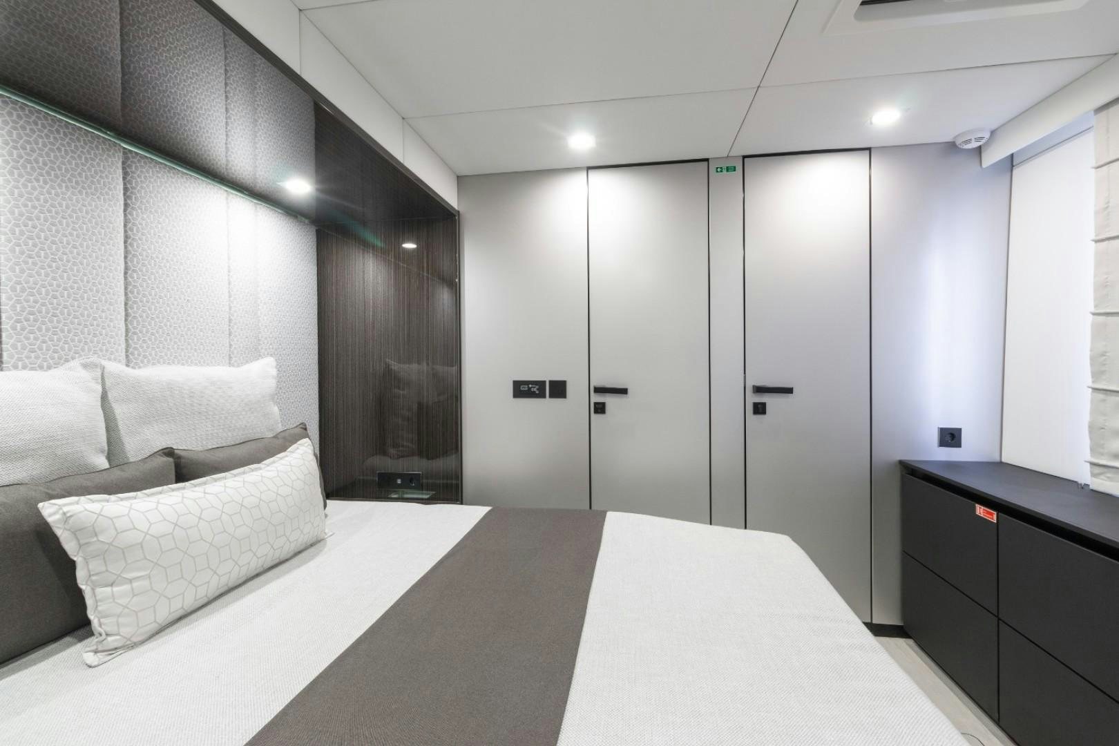 a room with a bed and a desk aboard OCEAN VIBES Yacht for Sale