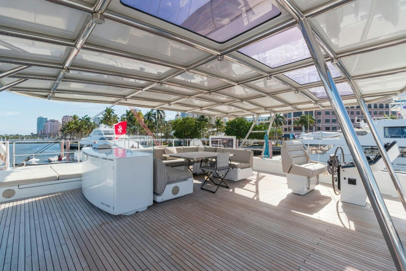 a room with a table and chairs aboard OCEAN VIBES Yacht for Sale