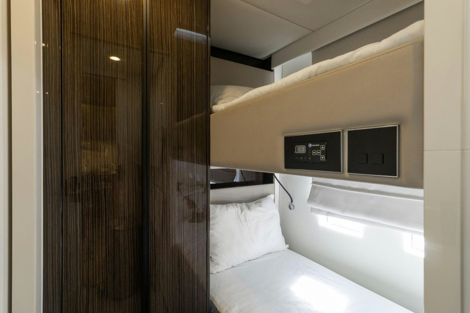 a room with a bed and a closet aboard OCEAN VIBES Yacht for Sale