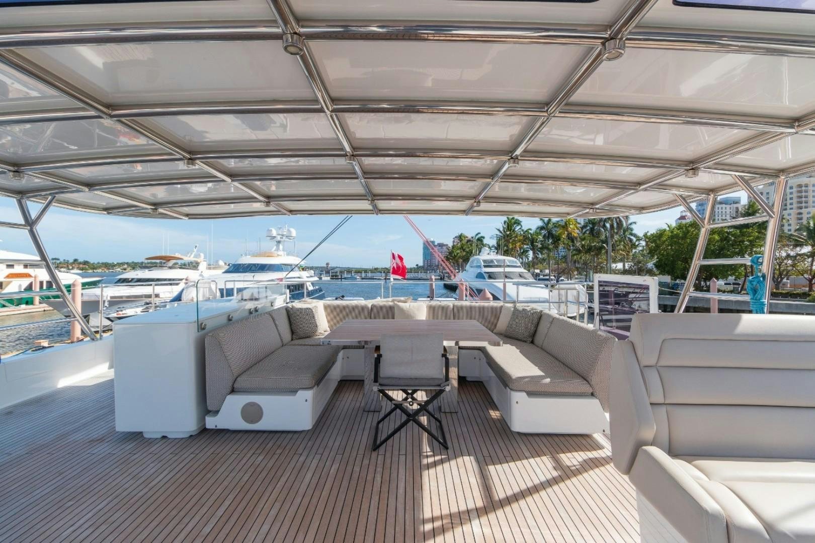 a deck with couches and chairs aboard OCEAN VIBES Yacht for Sale
