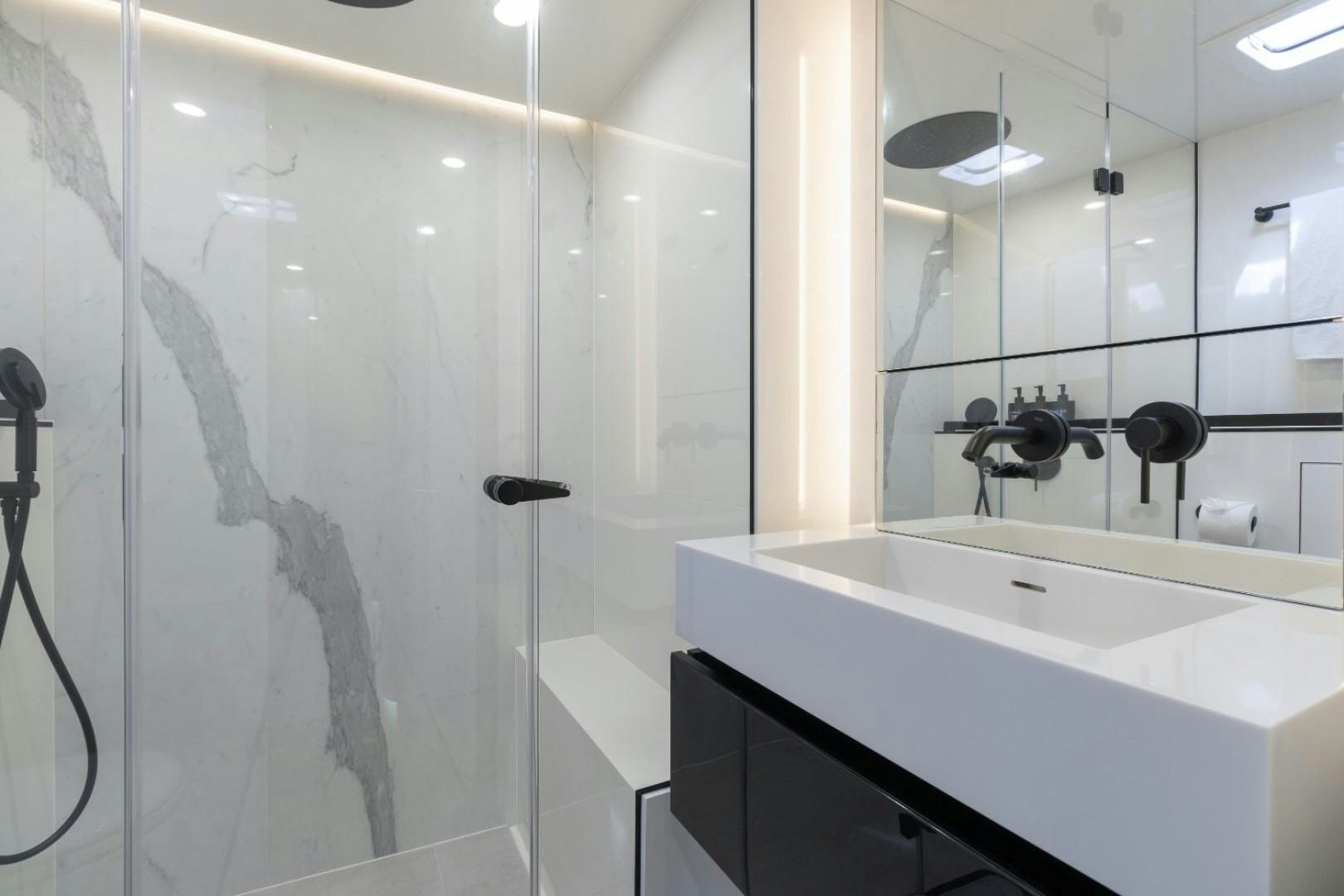 a bathroom with a shower and sink aboard OCEAN VIBES Yacht for Sale