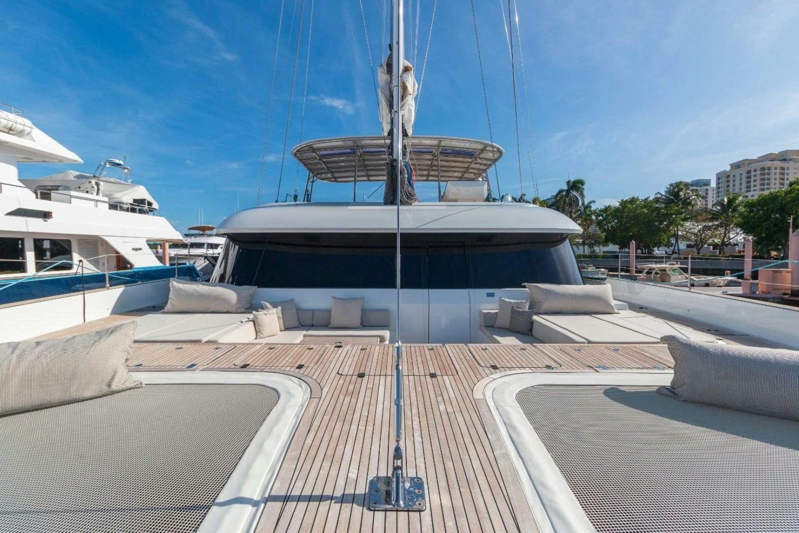 a large white boat with a black roof aboard OCEAN VIBES Yacht for Sale