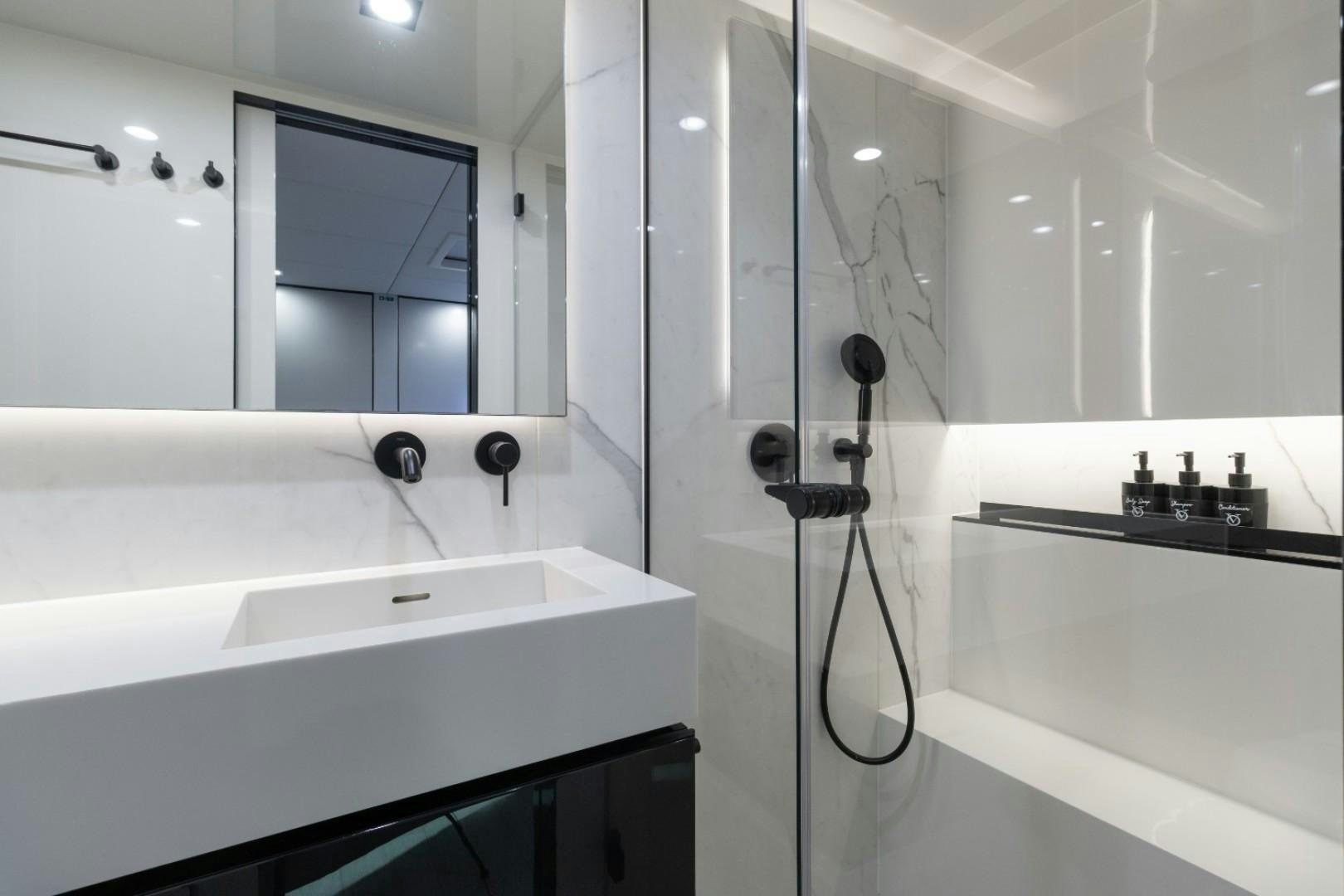 a bathroom with a shower unit and sink aboard OCEAN VIBES Yacht for Sale