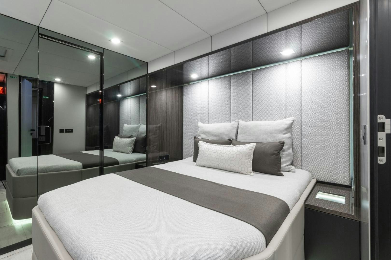 a room with a bed and a couch aboard OCEAN VIBES Yacht for Sale